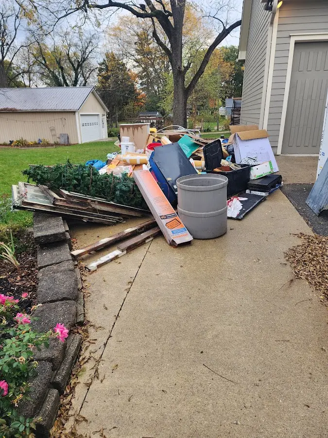 Dumpster being loaded with debris for Residential Dumpster Rental in Granville